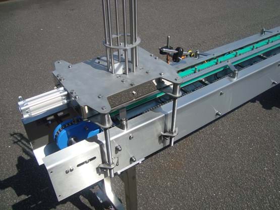Pot dispenser mounted over index conveyor